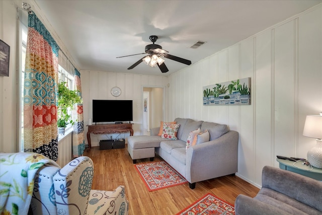 111 Circle Dr, Cleveland, TX 77327 - living area with light wood-style floors, a decorative wall, and ceiling fan