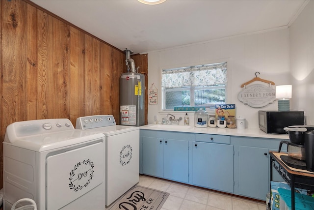 111 Circle Dr, Cleveland, TX 77327 - washroom with water heater, washing machine and clothes dryer, ornamental molding, and light tile patterned floors