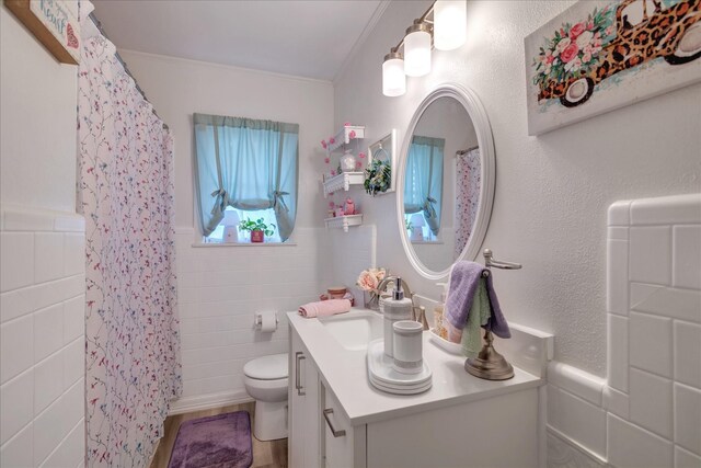 111 Circle Dr, Cleveland, TX 77327 - full bathroom featuring tile walls, vanity, crown molding, a shower with curtain, and wainscoting