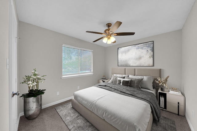carpeted bedroom featuring baseboards and a ceiling fan