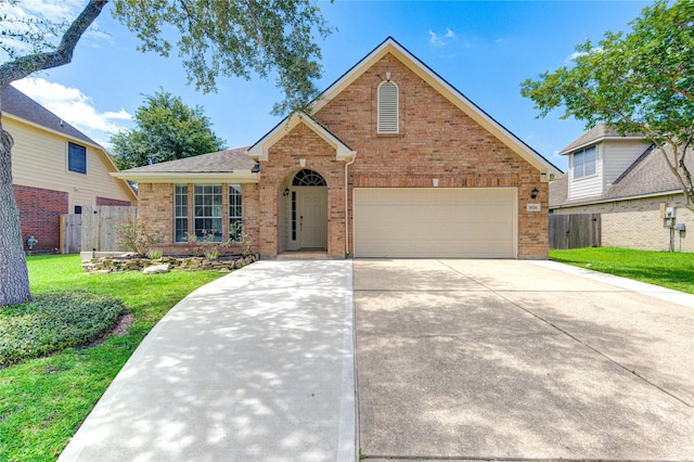 1826 Oak Lodge Dr, Pearland, TX 77581 - traditional-style house featuring brick siding, a garage, and concrete driveway