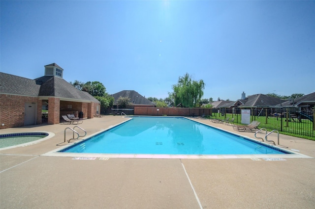 1826 Oak Lodge Dr, Pearland, TX 77581 - community pool featuring a patio, fence, and a community hot tub