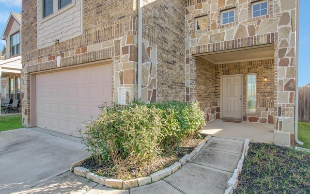 3514 Vivaldi Dr, Katy, TX 77493 - entrance to property featuring an attached garage, driveway, stone siding, and brick siding