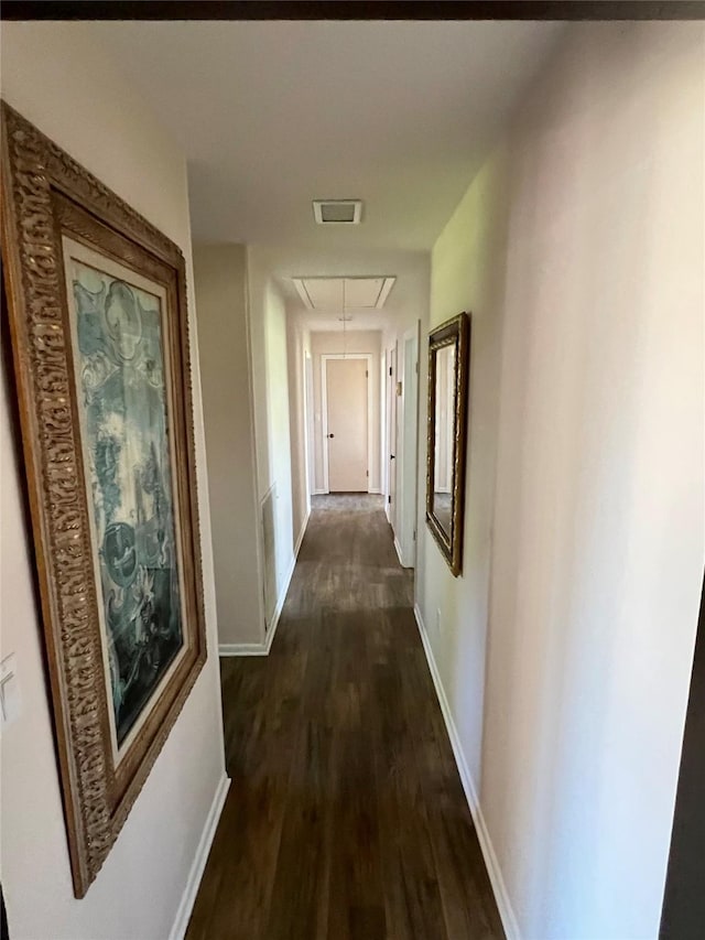 205 Cathy Dr, Hallettsville, TX 77964 - hallway with attic access, dark wood-type flooring, and baseboards