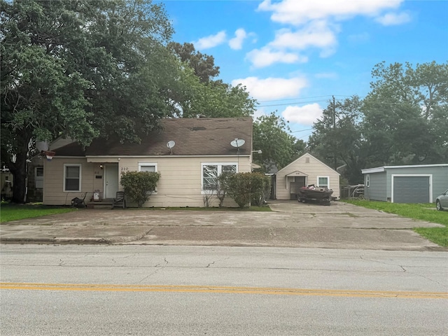 210 Park St, Baytown, TX 77520 - view of front of home with entry steps, an outbuilding, and concrete driveway