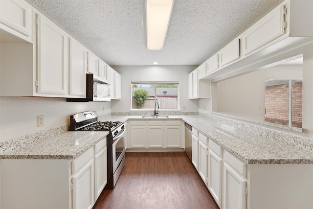 12215 Oldenburg Ln, Houston, TX 77065 - kitchen featuring stainless steel appliances, white cabinetry, dark wood-type flooring, light stone countertops, and a sink