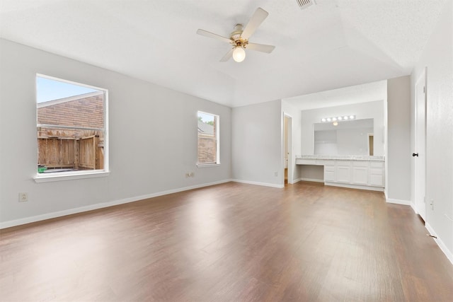 12215 Oldenburg Ln, Houston, TX 77065 - unfurnished bedroom featuring wood finished floors, baseboards, lofted ceiling, and ceiling fan