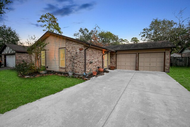 15011 Cypress Ridge Dr, Cypress, TX 77429 - view of front facade featuring a garage, concrete driveway, a front lawn, and brick siding