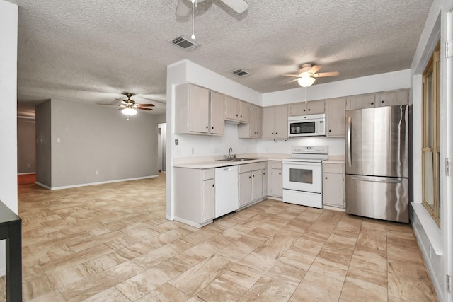 15011 Cypress Ridge Dr, Cypress, TX 77429 - kitchen with white appliances, ceiling fan, light countertops, a textured ceiling, and a sink