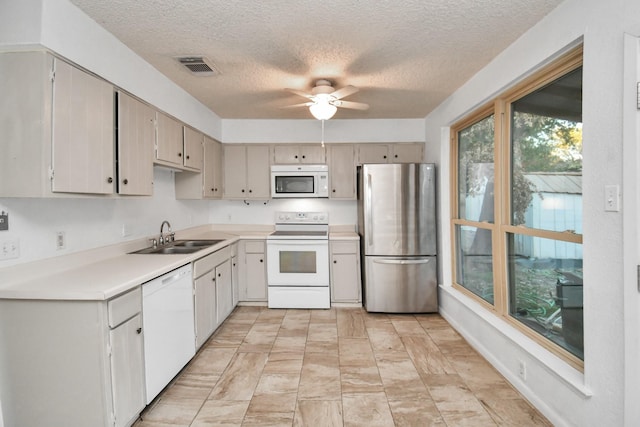 15011 Cypress Ridge Dr, Cypress, TX 77429 - kitchen featuring white appliances, a sink, a textured ceiling, light countertops, and ceiling fan