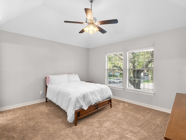 bedroom with carpet floors, baseboards, a ceiling fan, and vaulted ceiling