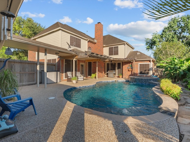 view of pool with a patio area, a fenced backyard, and a pool with connected hot tub