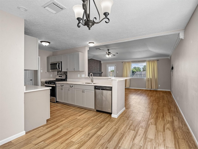 1726 Meadow Green Dr, Missouri City, TX 77489 - kitchen featuring stainless steel appliances, a sink, light countertops, ceiling fan, and light wood finished floors