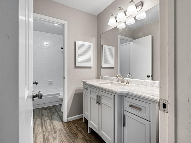 1726 Meadow Green Dr, Missouri City, TX 77489 - bathroom featuring wood finished floors, vanity, toilet, shower / washtub combination, and baseboards