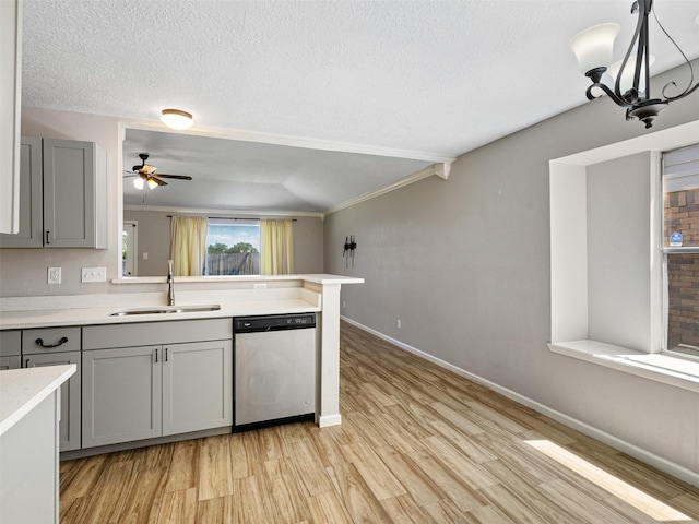 1726 Meadow Green Dr, Missouri City, TX 77489 - kitchen with dishwasher, a sink, gray cabinets, light wood-style floors, and a textured ceiling