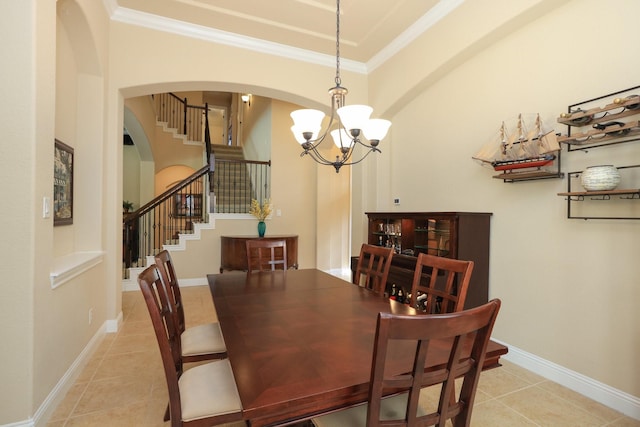 dining area with a chandelier, light tile patterned floors, stairs, crown molding, and arched walkways