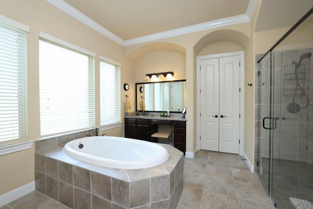 bathroom with crown molding, a bath, a shower stall, vanity, and baseboards