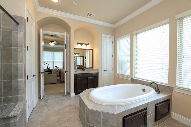 bathroom with ornamental molding, a garden tub, a ceiling fan, vanity, and baseboards