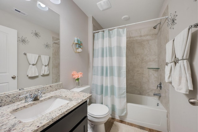 2065 Chief St, Bryan, TX 77807 - full bathroom featuring toilet, vanity, shower / bath combination with curtain, and wood finished floors