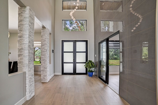 26511 Meadow Ln, Katy, TX 77494 - foyer with french doors, wood finished floors, a towering ceiling, baseboards, and ornate columns