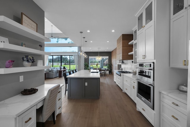 26511 Meadow Ln, Katy, TX 77494 - kitchen featuring open shelves, stainless steel appliances, a kitchen island with sink, white cabinets, and decorative light fixtures