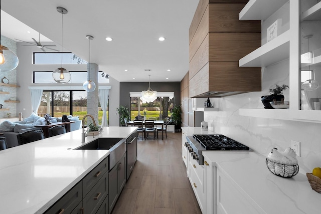 26511 Meadow Ln, Katy, TX 77494 - kitchen featuring a sink, ceiling fan, decorative light fixtures, light wood-style floors, and decorative backsplash