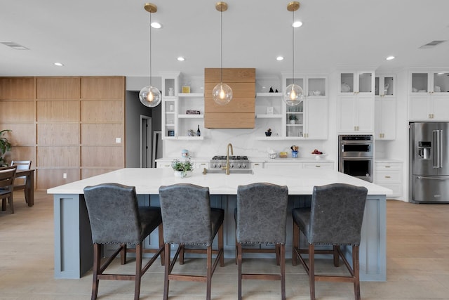 26511 Meadow Ln, Katy, TX 77494 - kitchen with stainless steel appliances, open shelves, light countertops, decorative light fixtures, and recessed lighting