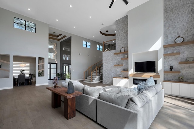 26511 Meadow Ln, Katy, TX 77494 - living area with a towering ceiling, stairs, plenty of natural light, light wood finished floors, and baseboards