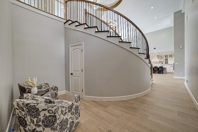 26511 Meadow Ln, Katy, TX 77494 - stairs with a high ceiling, wood finished floors, and baseboards