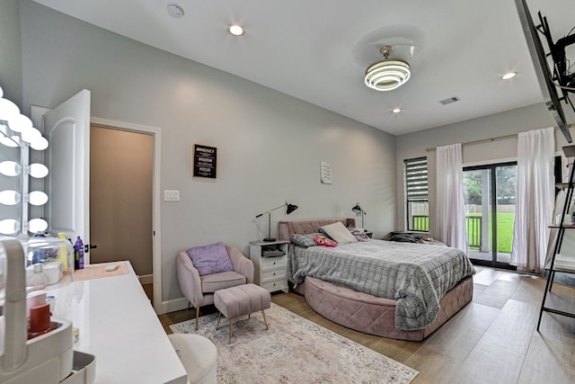 26511 Meadow Ln, Katy, TX 77494 - bedroom with access to exterior, light wood-style floors, and recessed lighting