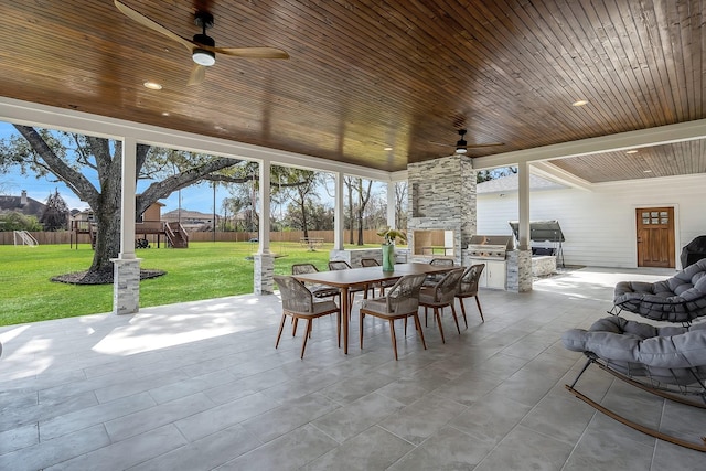 26511 Meadow Ln, Katy, TX 77494 - view of patio / terrace featuring an outdoor kitchen, outdoor dining space, a ceiling fan, a grill, and a playground