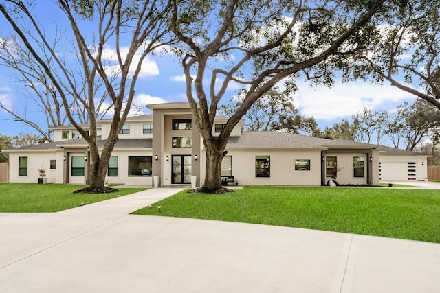 26511 Meadow Ln, Katy, TX 77494 - prairie-style home featuring stucco siding, a front lawn, a garage, and roof with shingles