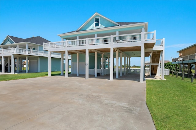 3025 Carioca Ct, Crystal Beach, TX 77650 - rear view of house with a carport, concrete driveway, and a yard