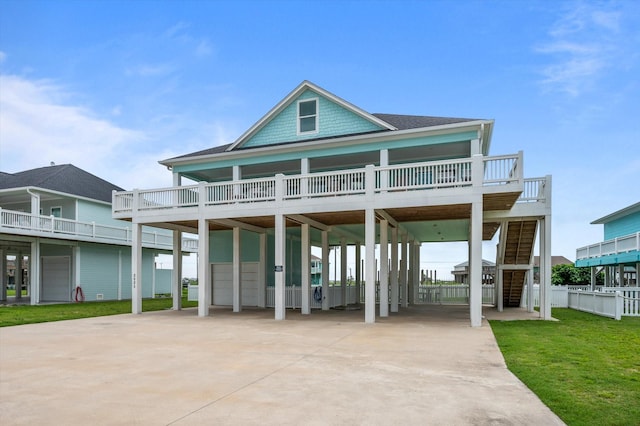 3025 Carioca Ct, Crystal Beach, TX 77650 - back of property with a carport, driveway, a lawn, and stairs