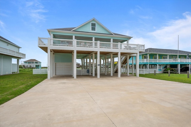 3025 Carioca Ct, Crystal Beach, TX 77650 - view of front of property with a carport, a front yard, concrete driveway, and stairs