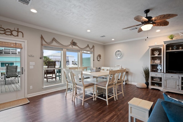 3025 Carioca Ct, Crystal Beach, TX 77650 - dining space featuring dark wood-style flooring, baseboards, ceiling fan, recessed lighting, and crown molding