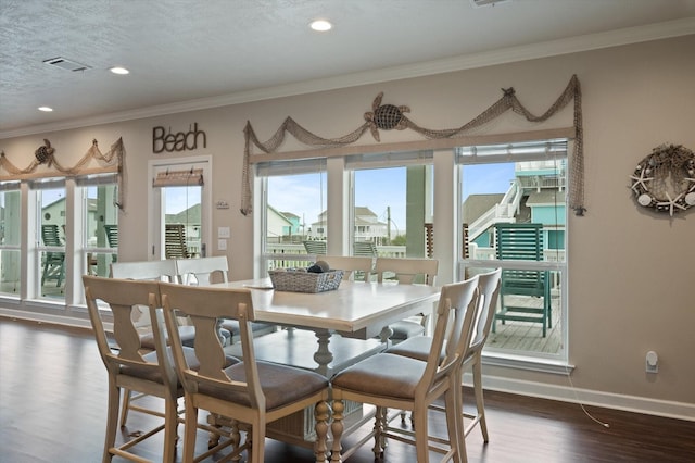3025 Carioca Ct, Crystal Beach, TX 77650 - dining room with plenty of natural light, dark wood finished floors, ornamental molding, baseboards, and recessed lighting