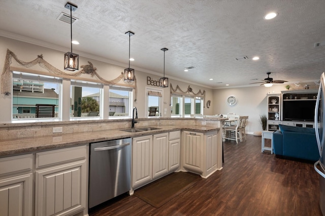 3025 Carioca Ct, Crystal Beach, TX 77650 - kitchen with stainless steel appliances, a sink, dark wood-type flooring, ornamental molding, and light stone counters