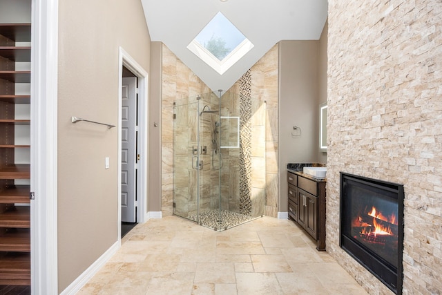2911 S Saddlebrook Ln, Katy, TX 77494 - bathroom with vanity, a stall shower, a fireplace, a skylight, and lofted ceiling