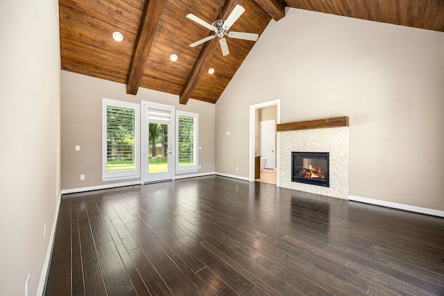 2911 S Saddlebrook Ln, Katy, TX 77494 - unfurnished living room with high vaulted ceiling, a ceiling fan, a glass covered fireplace, dark wood-style floors, and a wooden ceiling with exposed beams