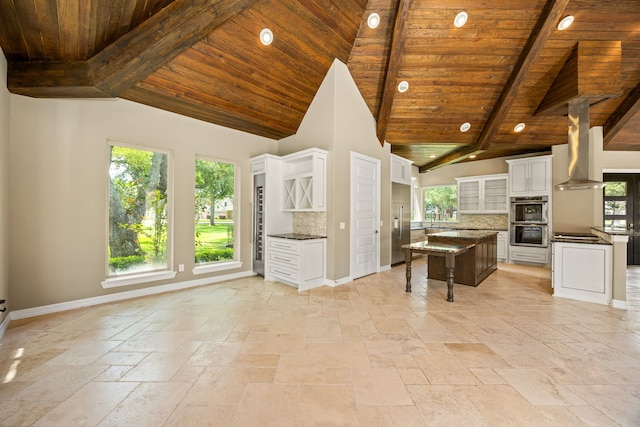 2911 S Saddlebrook Ln, Katy, TX 77494 - kitchen with wall chimney exhaust hood, a wooden ceiling with exposed beams, stainless steel appliances, stone tile floors, and tasteful backsplash