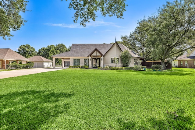 2911 S Saddlebrook Ln, Katy, TX 77494 - tudor home with french doors, a front yard, concrete driveway, and stucco siding