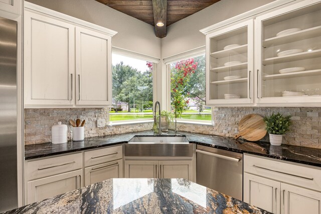 2911 S Saddlebrook Ln, Katy, TX 77494 - kitchen featuring stainless steel appliances, tasteful backsplash, dark stone counters, white cabinetry, and glass insert cabinets