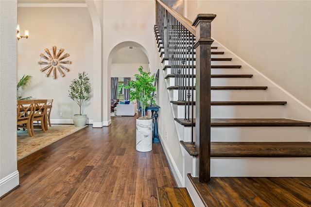 9811 Mount Shasta, Missouri City, TX 77459 - stairs featuring arched walkways, wood finished floors, and a high ceiling