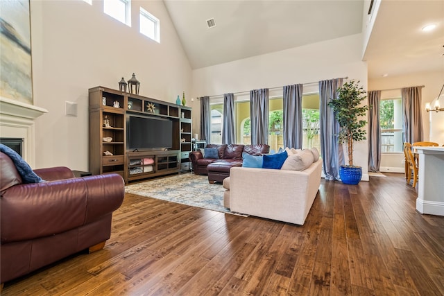 9811 Mount Shasta, Missouri City, TX 77459 - living area featuring high vaulted ceiling, a chandelier, dark wood-style floors, healthy amount of natural light, and a fireplace