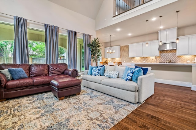 9811 Mount Shasta, Missouri City, TX 77459 - living room featuring dark wood-style flooring, high vaulted ceiling, and a chandelier