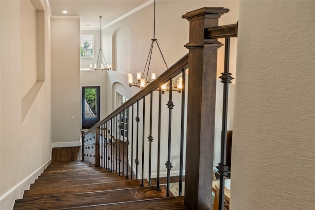 9811 Mount Shasta, Missouri City, TX 77459 - stairway featuring wood finished floors, crown molding, a chandelier, arched walkways, and a towering ceiling