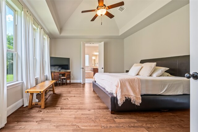 9811 Mount Shasta, Missouri City, TX 77459 - bedroom featuring a raised ceiling, wood finished floors, ensuite bath, and ceiling fan