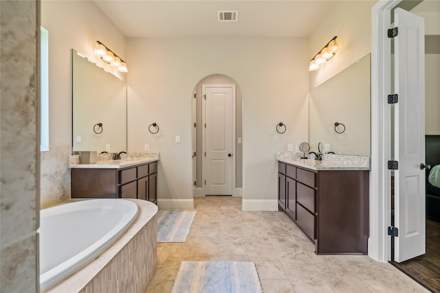 9811 Mount Shasta, Missouri City, TX 77459 - full bathroom featuring two vanities and a relaxing tiled tub
