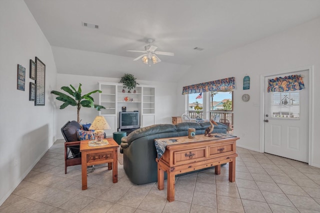 living area featuring lofted ceiling, a ceiling fan, light tile patterned floors, and baseboards